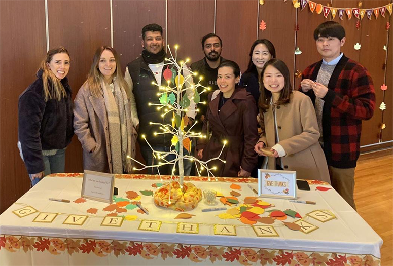 During a traditional Thanksgiving Lunch hosted by the program, Ivonne (first from left) and her classmates write what they are thankful for and put it on our “Thankful Tree”. 