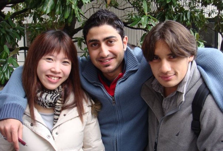 Levent, center, poses with tow of his classmates. He still keep in touch with them, mostly through social media