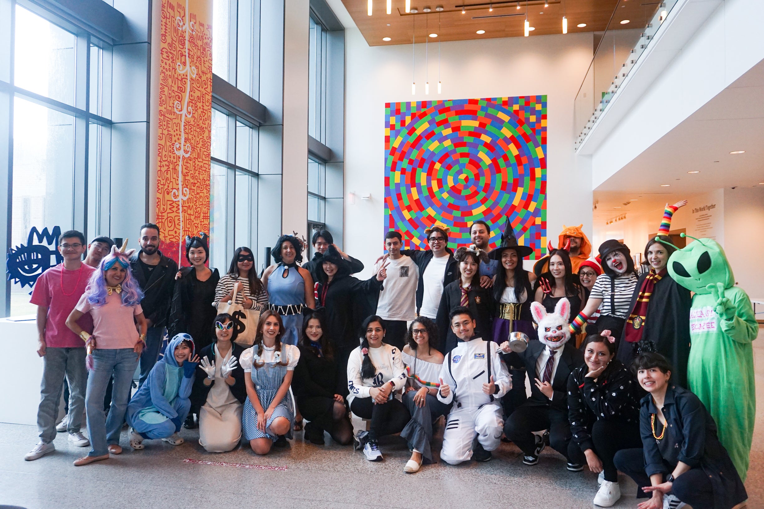 a group of adult students wearing halloween costumes