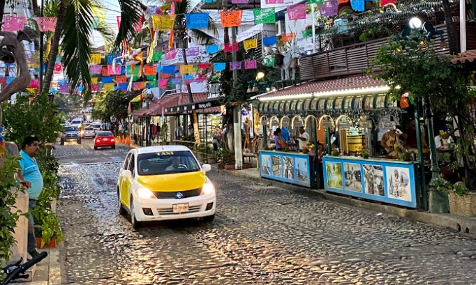 a taxi drives down a street in Mexico