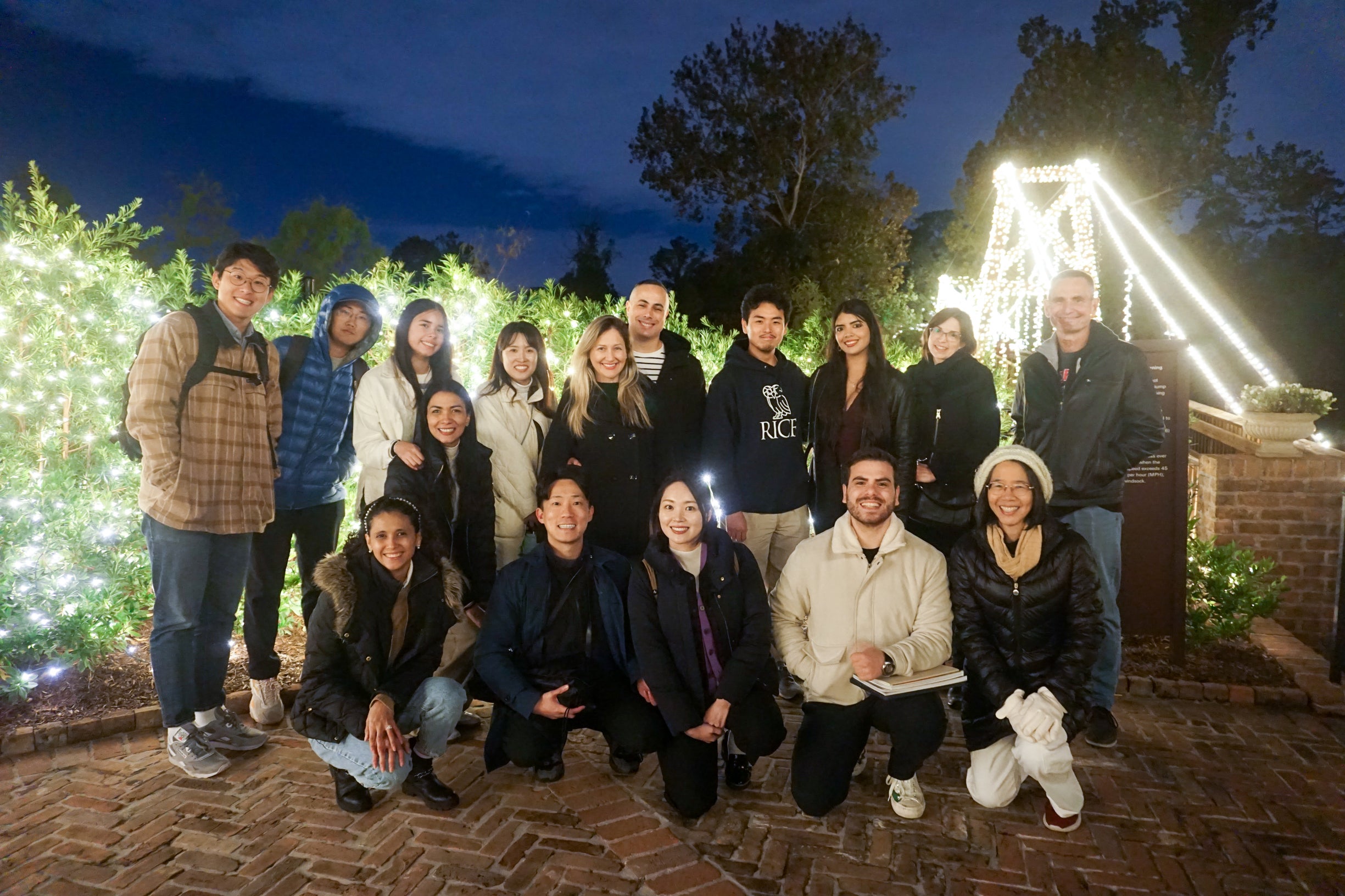 international students posing in front of Christmas lights at a park