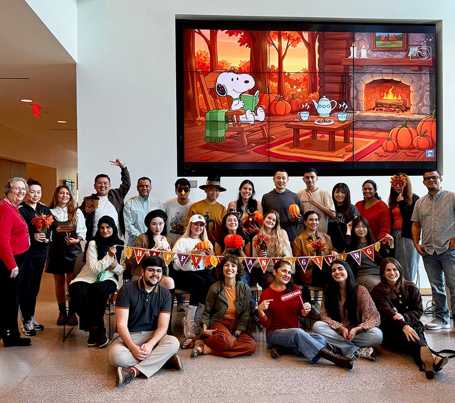 students and teachers posing for picture at Thanksgiving party