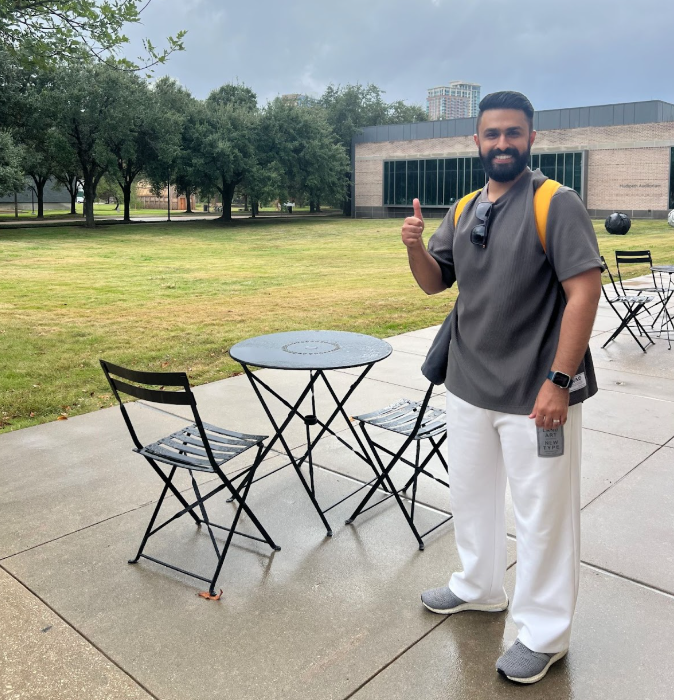 male student standing outside building