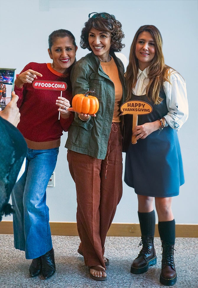 three women posing for a Thanksgiving picture