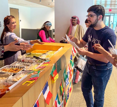 international students submitting completed cross word puzzles for a contest