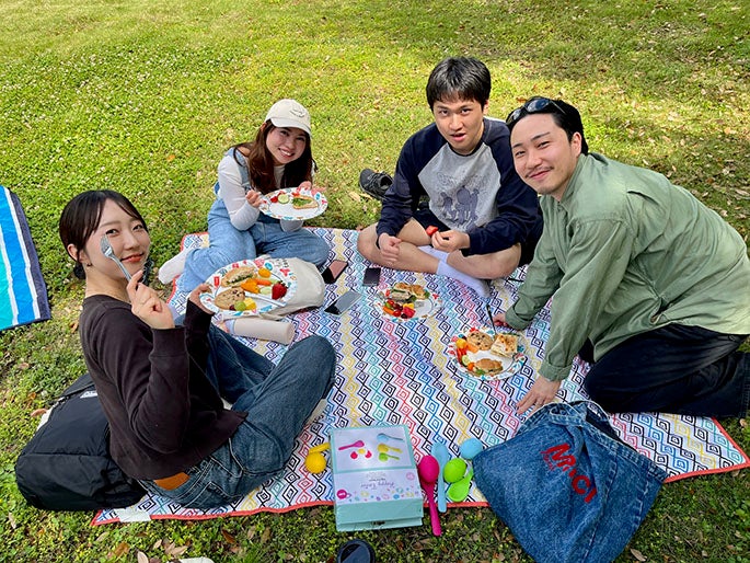 college students having a picnic outside
