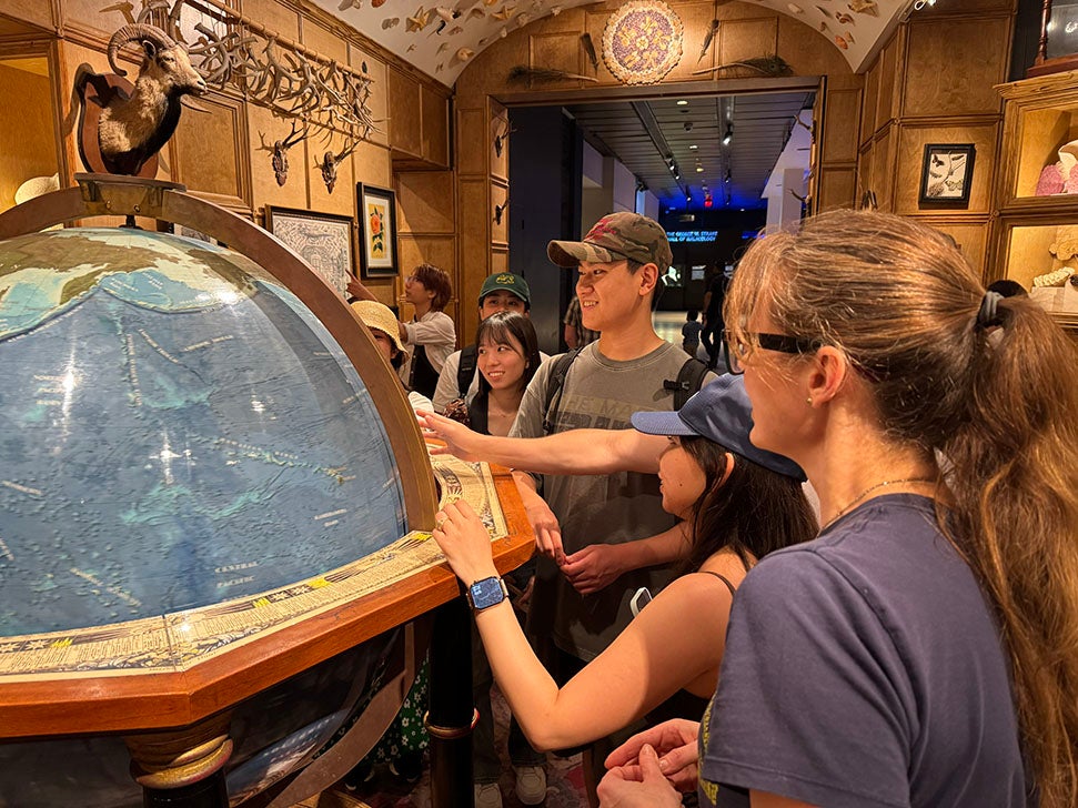 adults looking at a globe in a history museum