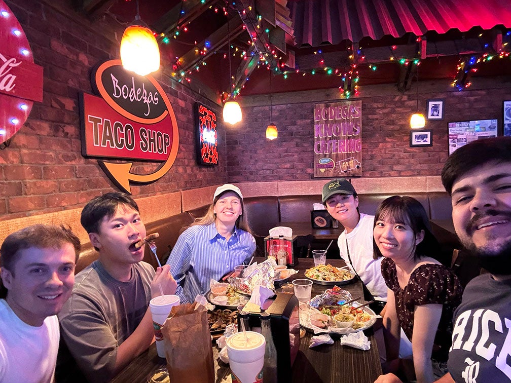 adults having dinner together at a taco shop