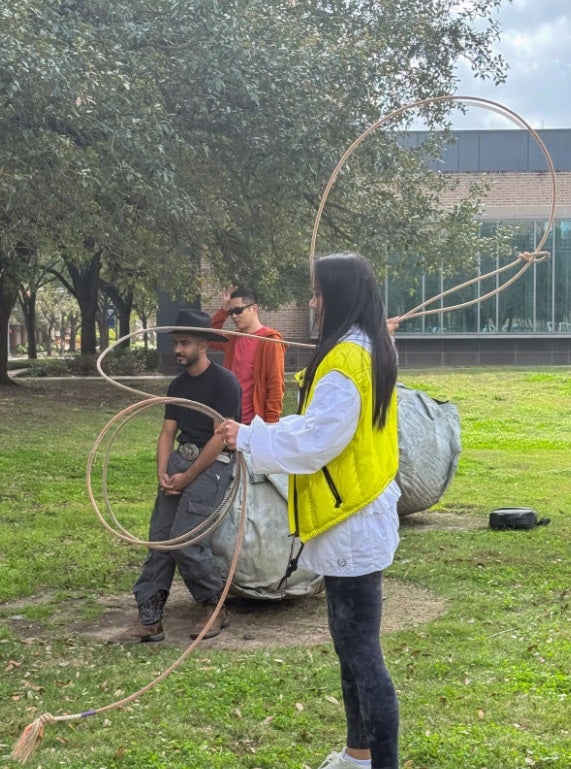 adult female learning to rope cattle outside