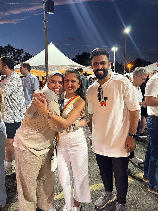 female and male student with teacher at outdoor festival