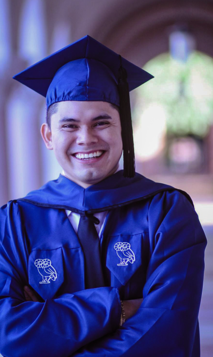 male college student in his cap and gown