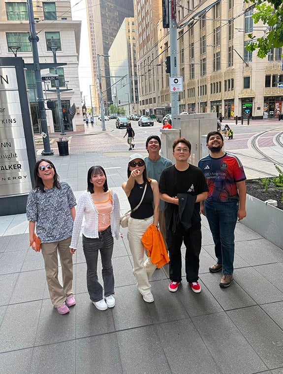 group of adults in downtown Houston walking in the street