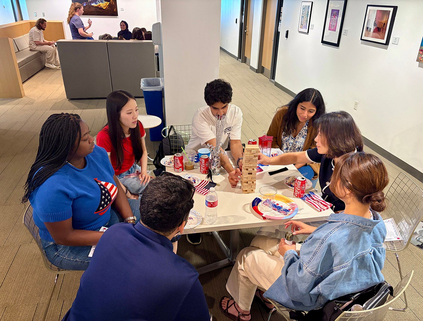adult students playing jenga around a table
