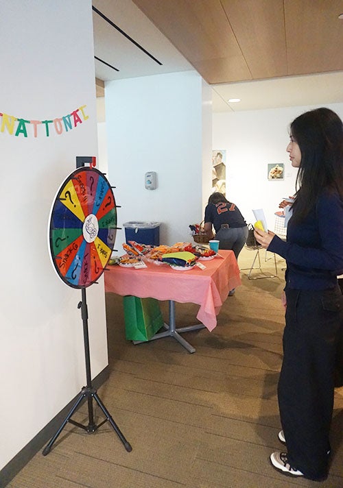 adult female student looking at prize wheel