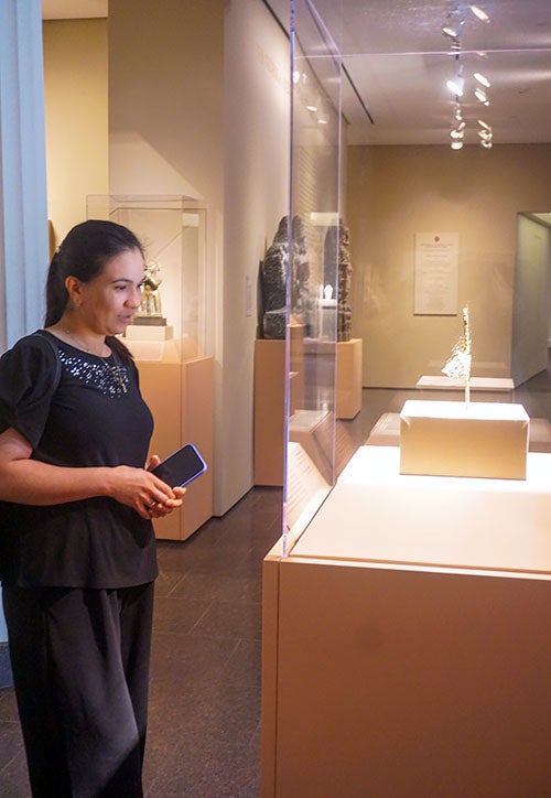 woman looking at exhibit inside an art museum