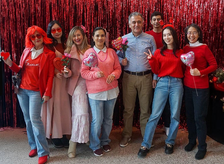 group of adult students gathered in at Valentine's Day party