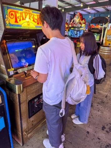 a Taiwanese and Japanese student play arcade games
