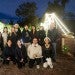 international students posing in front of Christmas lights at a park
