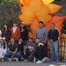 a group of young adults posing together in front of a fall display at the zoo