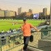 Chinese male student standing in front of baseball field