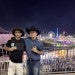 two male students posing in front of a rodeo carnival